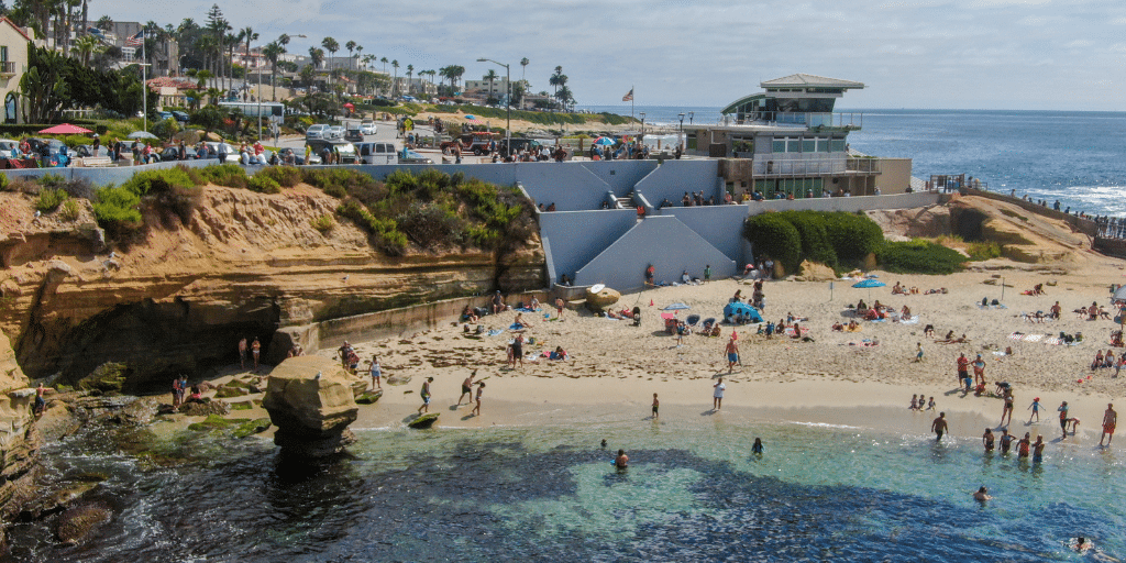 photo of la jolla cove with crowded beach showing the cost of living in san diego