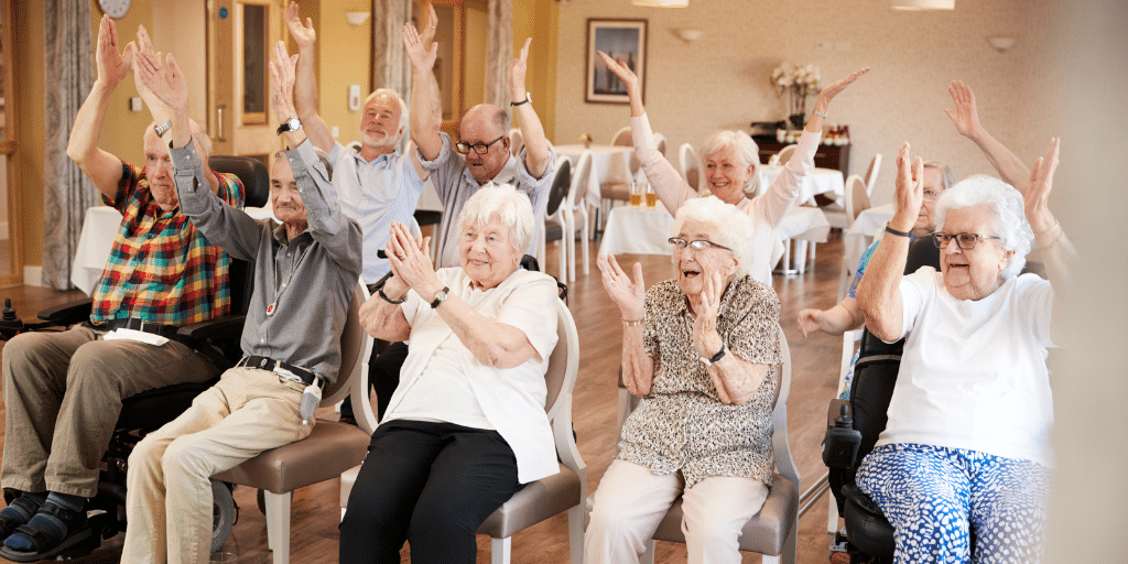 photo of seniors in a healthcare facility clapping and cheering showing what is san diego known for