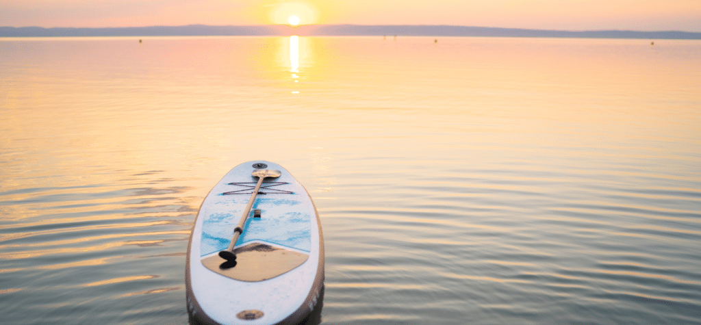 photo of paddle board in the ocean with a sunset showing is san diego a good place to live