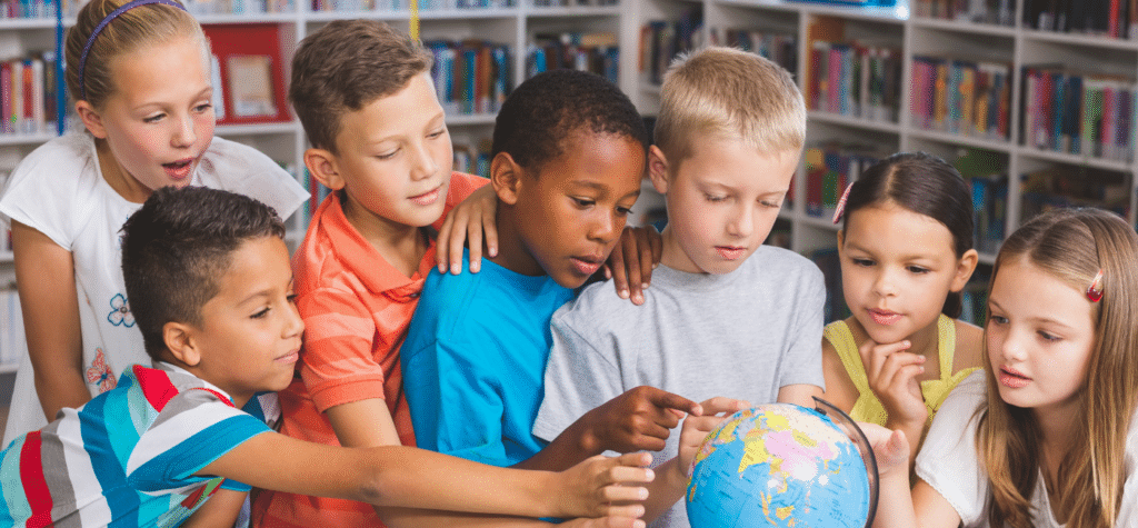 photo of kids in school all touching a globe showing is san diego a good place to live